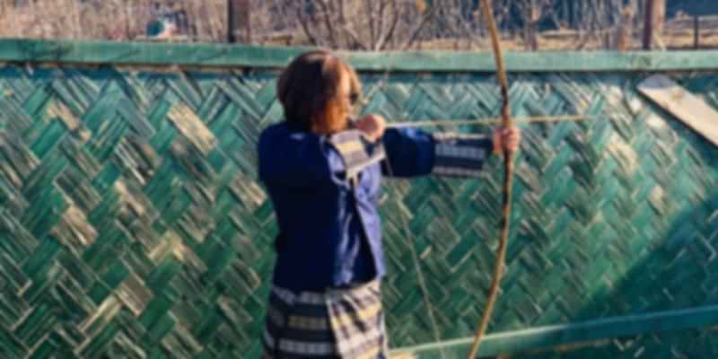 Trying out the national sport, archery during my solo trip to Bhutan