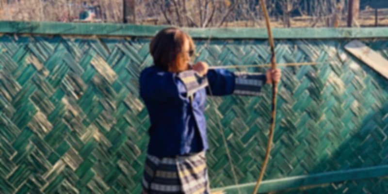 Trying out the national sport, archery during my solo trip to Bhutan