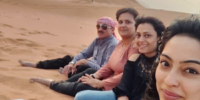 A group of people enjoy the sunset in the Desert Safari