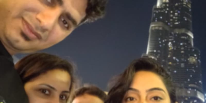 A group of people posing at the Burj Khalifa in Dubai