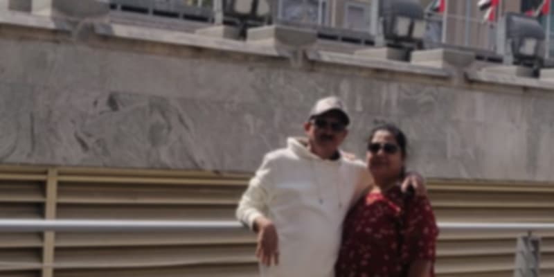 A couple posing for a picture in front of the Dubai Mall