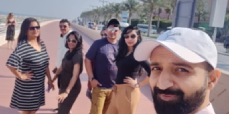 A group of people posing at the beach on their family trip to Dubai