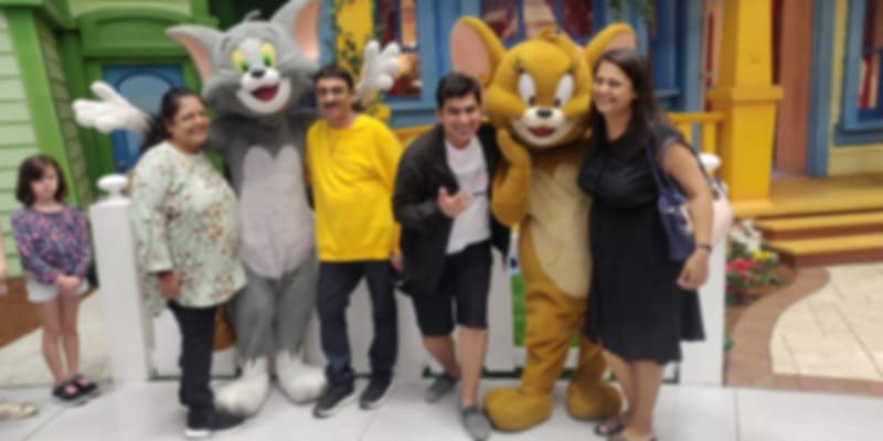 A group of people posing with the Mickey mouse on their trip to Dubai