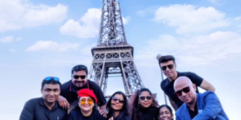 A group of friends with the shining Eiffel Tower as the background