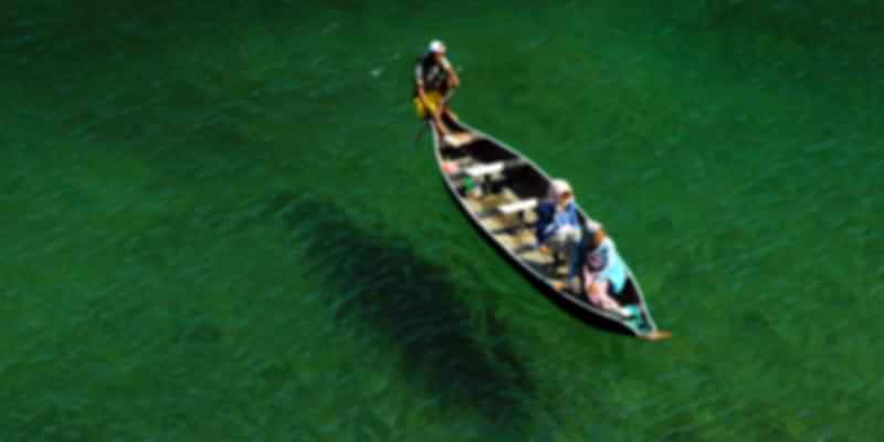 A picture of three people boating in Northeast India