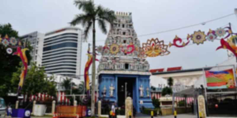 Sri Srinivasa Perumal Temple in Little India, Singapore, featuring a tall gopuram with vivid carvings and Hindu deities.