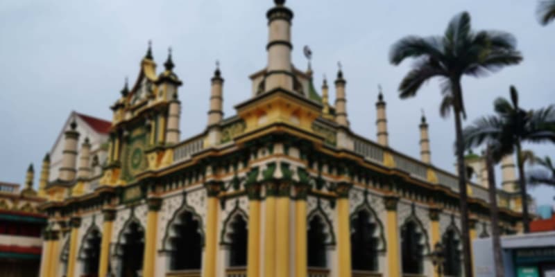 Abdul Gafoor Mosque in Singapore showcasing Saracenic and South Indian architectural styles with tall minarets and ornate detailing.