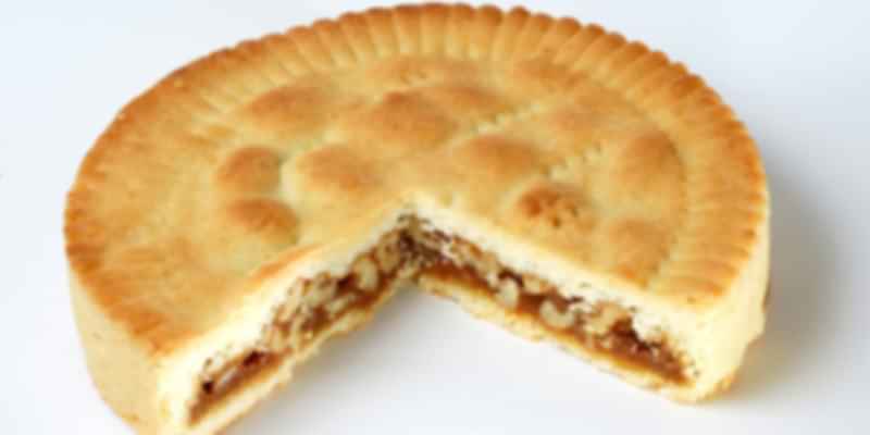 Whole Bündner Nusstorte nut tart filled with caramelized walnuts, a traditional Swiss dessert specialty.