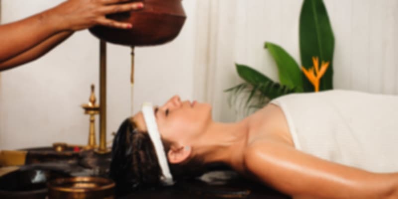 A woman receiving traditional Ayurvedic therapy in Kerala, symbolizing the state’s global reputation for holistic and wellness-based healthcare.