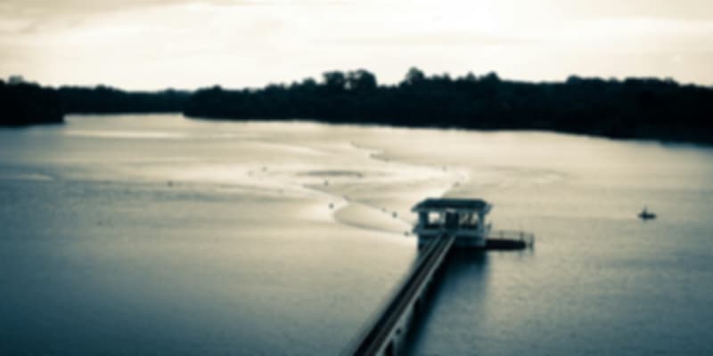 Scenic view of the wooden jetty over calm waters at MacRitchie Reservoir, a popular hiking and kayaking spot in Singapore