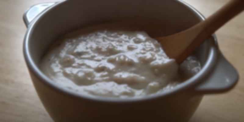Traditional Swiss roasted flour soup served warm in a ceramic bowl with a wooden spoon—a rustic mountain favorite.