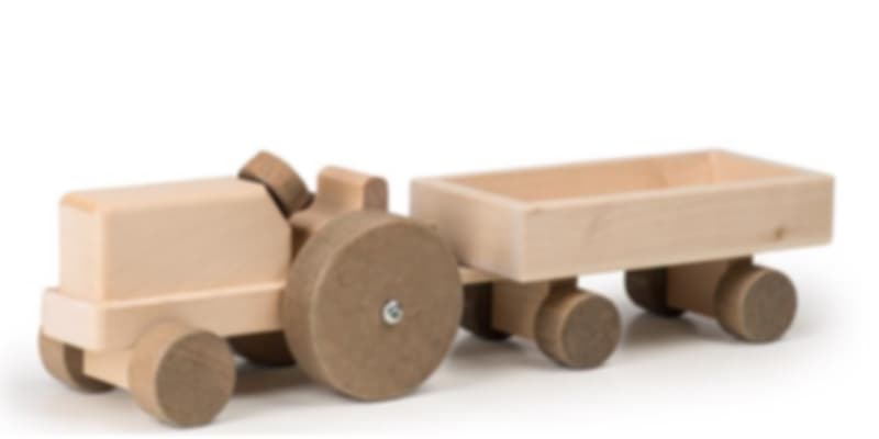 A handmade wooden toy tractor and trailer, crafted from light-colored, unpainted wood.