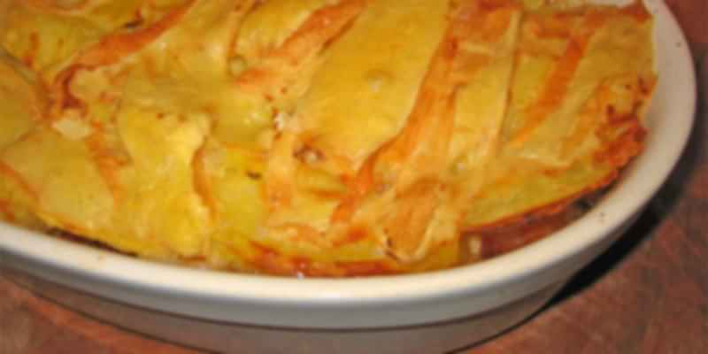 Baked Swiss tartiflette dish with layers of potatoes, reblochon cheese, onions, and bacon—a hearty alpine comfort food.