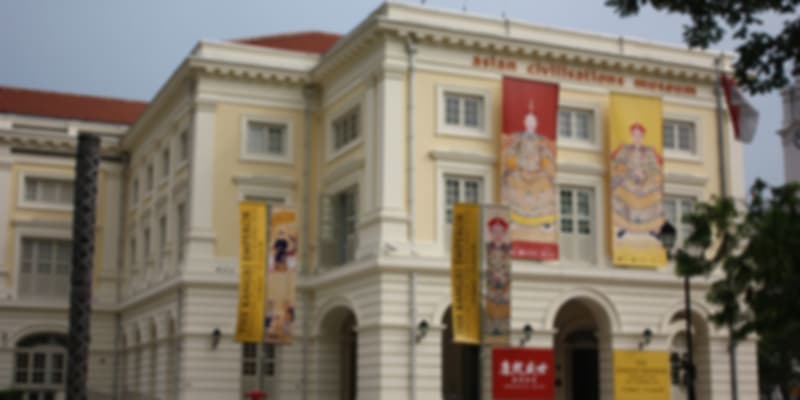 Asian Civilisations Museum with banners and trees in the foreground