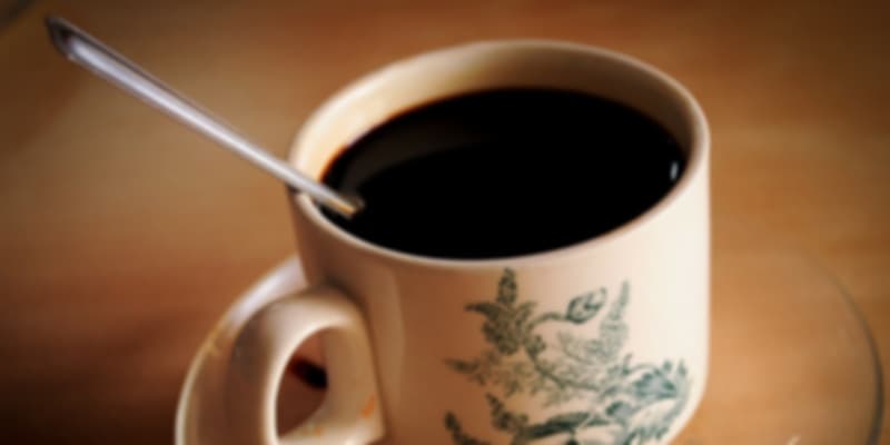 Classic Singapore coffee, Kopi and Kopi-O, served in a traditional white porcelain cup.