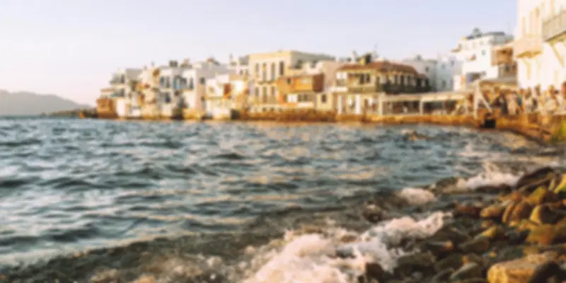 Popular party beaches in Mykonos with beach clubs, DJs, and crowds by the Aegean Sea