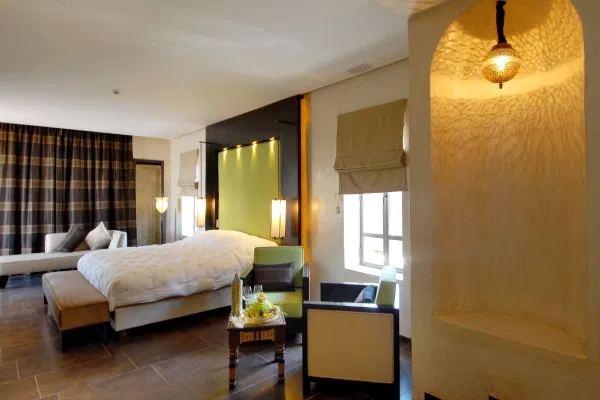 Spacious room at Andaz Capital Gate one of the best Abu Dhabi hotels, featuring contemporary interiors and floor-to-ceiling windows.