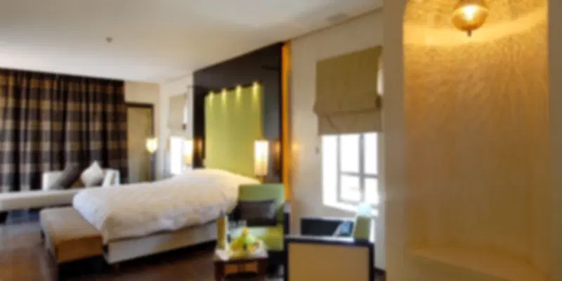Spacious room at Andaz Capital Gate one of the best Abu Dhabi hotels, featuring contemporary interiors and floor-to-ceiling windows.