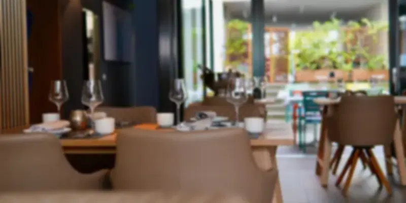 Elegant dining area at Moksh, one of the leading Michelin-starred Indian restaurants in Abu Dhabi, featuring contemporary interiors and a sophisticated fine-dining ambience.