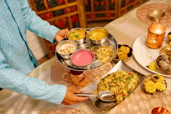 Traditional Indian thali and biryani served at Rangoli, showcasing authentic North and South Indian cuisine in a fine-dining setting.