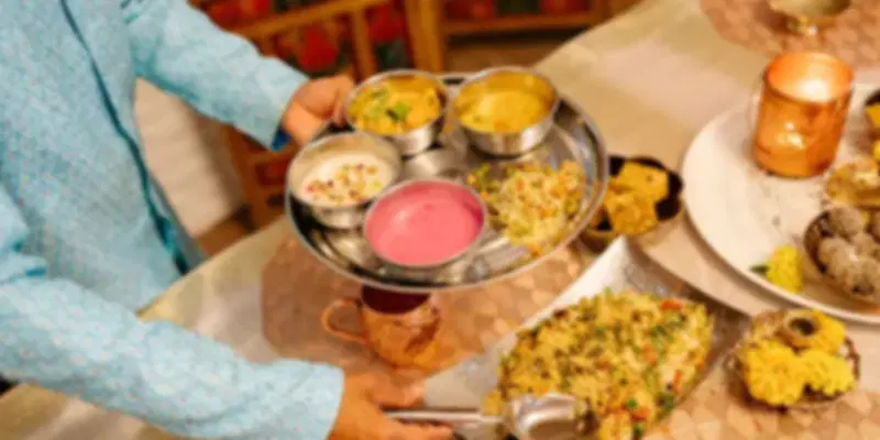 Traditional Indian thali and biryani served at Rangoli, showcasing authentic North and South Indian cuisine in a fine-dining setting.