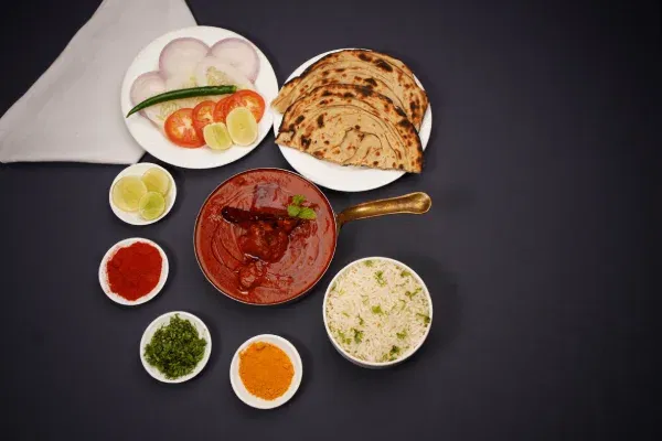 Signature butter chicken, naan, and fragrant basmati rice served at Zeera by Buddha Bar