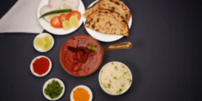 Signature butter chicken, naan, and fragrant basmati rice served at Zeera by Buddha Bar